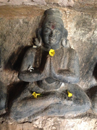 Stone figure in prayer position
